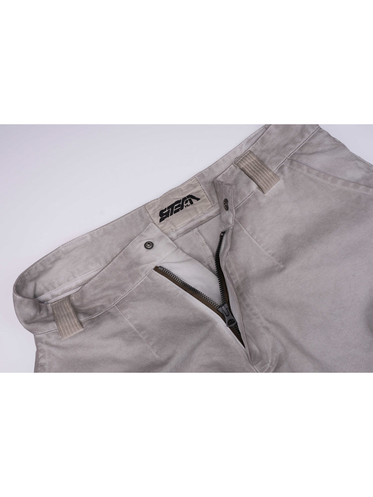PIONEER eris white welded multi-pocket work pants — waistband detail showing belt loops, snap closure, zipper fly and STEAM label