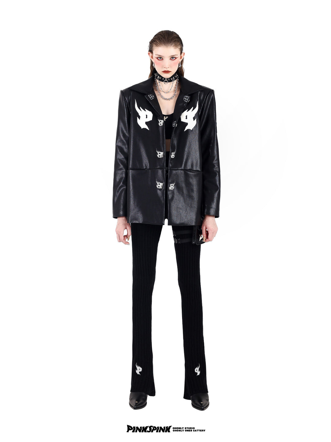 PINKSPINK SPIKE RING studded chain choker in black — full-length front modeled view with a black buckle jacket and flared trousers
