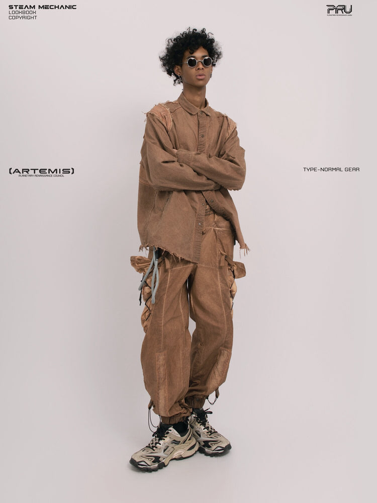 CHAOS ERA raw-edge technical shirt in brown — full-length angled front view with crossed arms