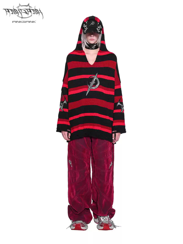 PINKSPINK ELECTRIC MOON striped hooded sweater in BLACK AND RED — full-body front view with hood over cap and red trousers.