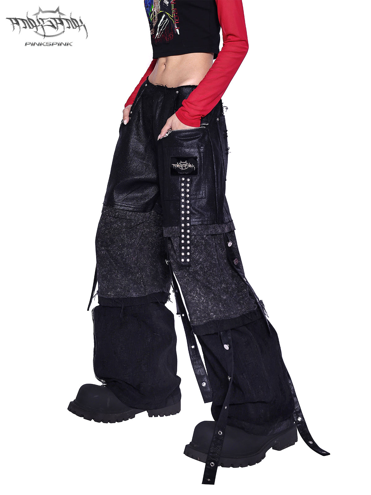 PINKSPINK RECOMBINATION stacked low-rise jeans in black — close view of the low-rise waist, washed panels and studded straps.