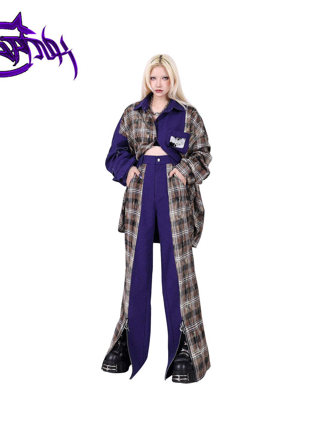 PINKSPINK DNA purple plaid split-panel wide-leg pants — front full-length modeled view with hands in the pockets