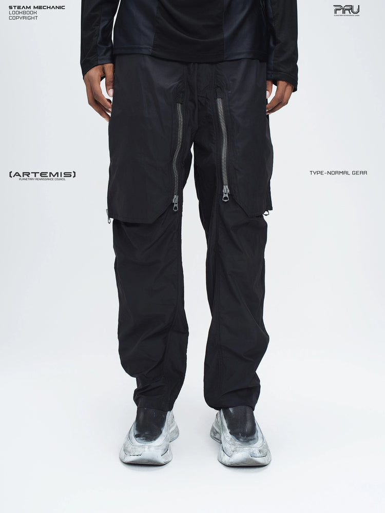 GAIA black curved-blade technical pants — front lower-body modeled view showing the closed curved zipper overlays