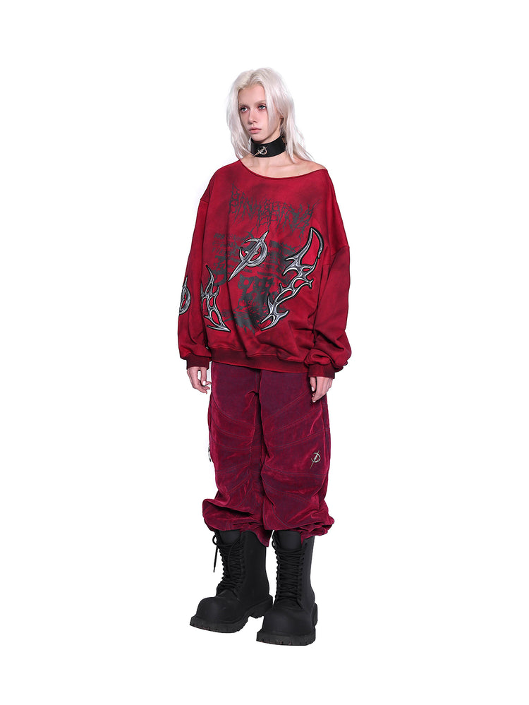 PINKSPINK ELECTRIC MOON off-shoulder sweatshirt in RED — three-quarter full-body view styled with red trousers.