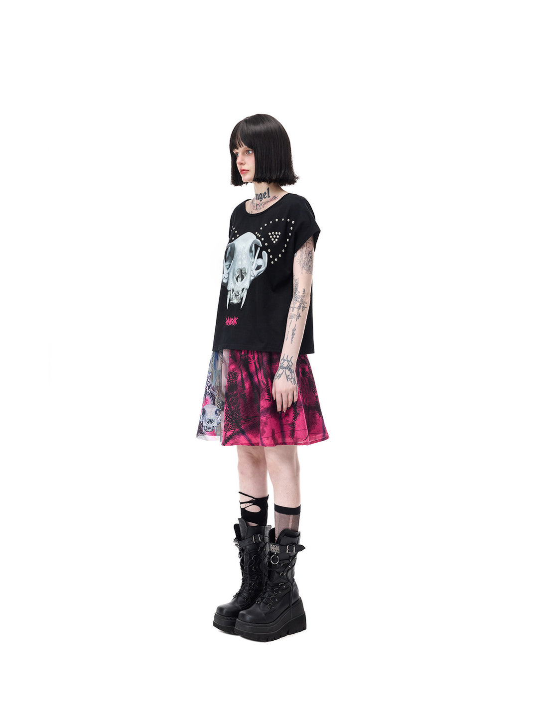 PINKSPINK CATACOMB reversible cat-skull tee in black — side cat-skull-face view styled with a separate graphic mini skirt