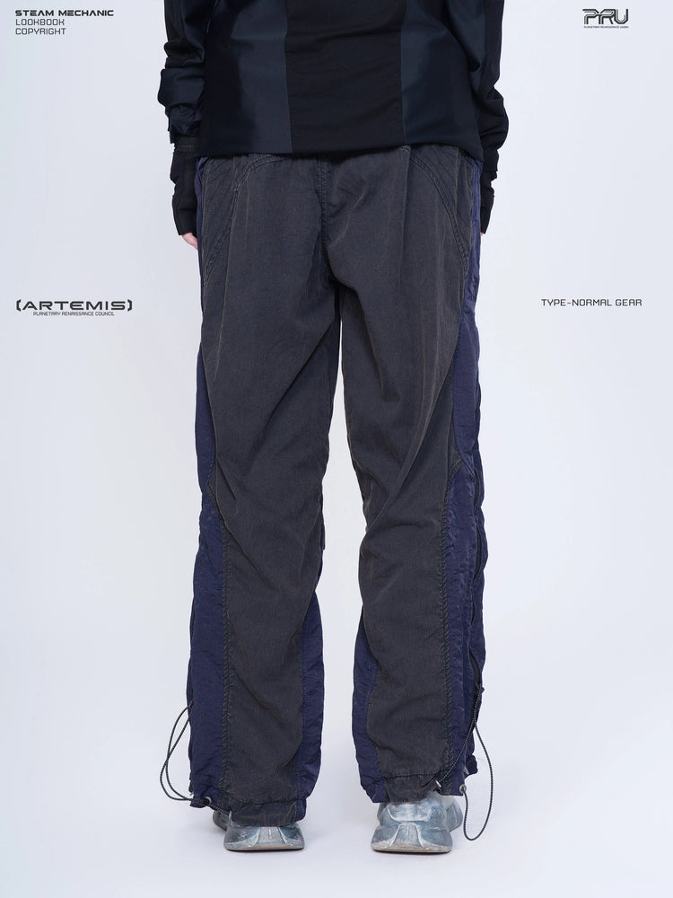 SUPERNOVA zima blue metallic nylon technical pants — rear modeled close-up showing curved panel seams