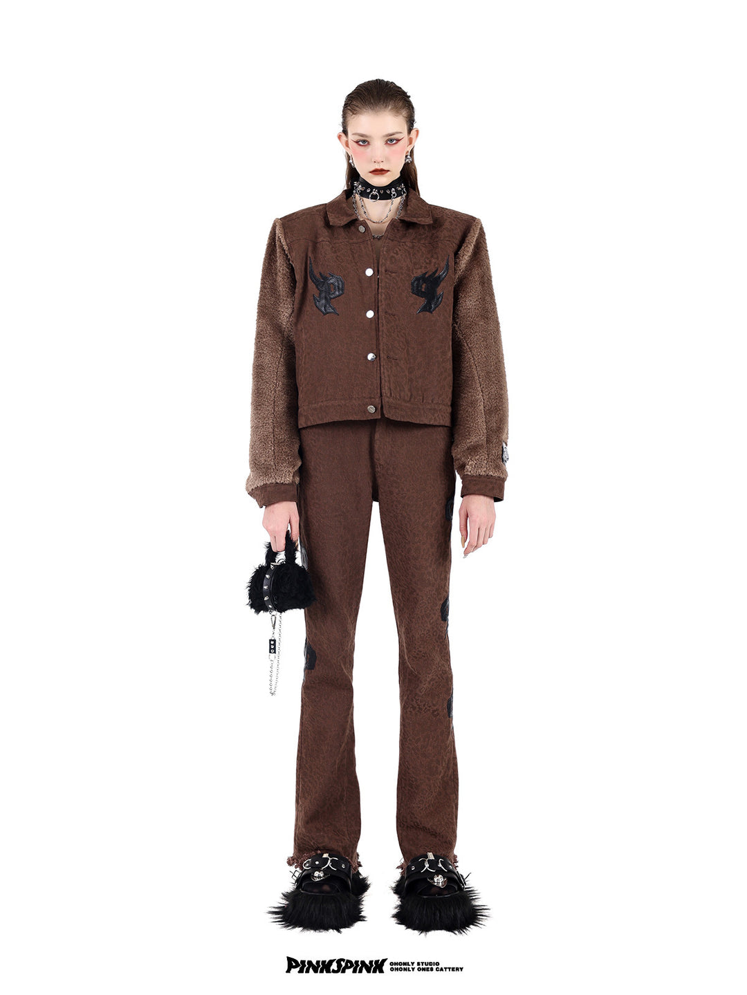 PINKSPINK SPIKE RING studded chain choker in black — full-length front modeled view with a brown jacket and matching trousers