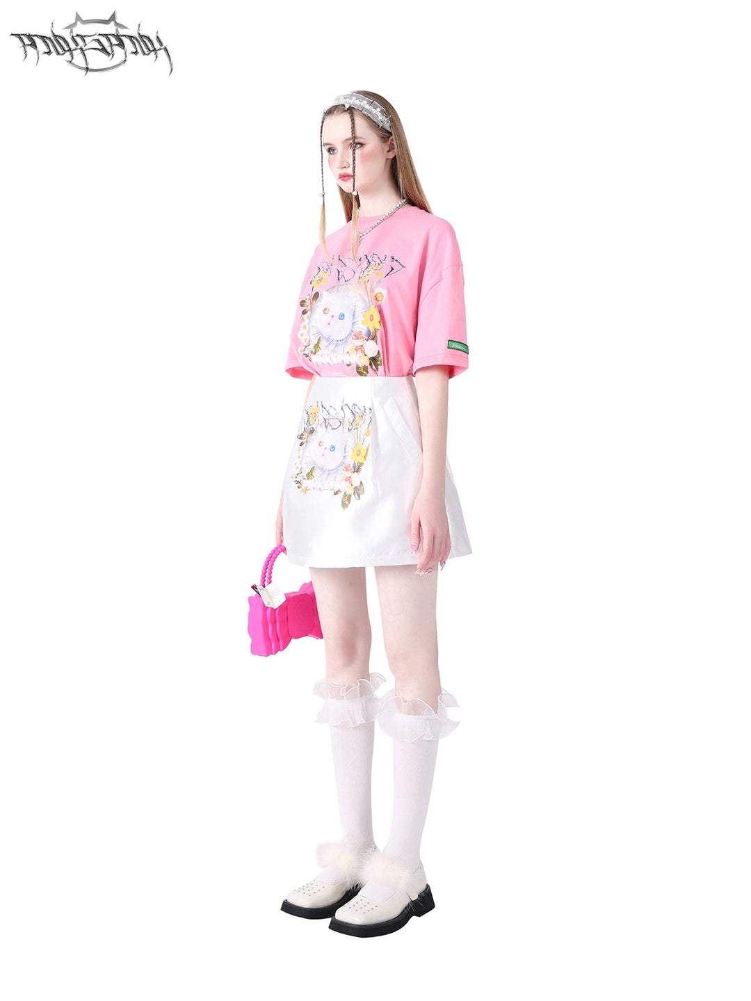 PINKSPINK GARFIELD oversized graphic tee — pink side modeled view styled with a white skirt