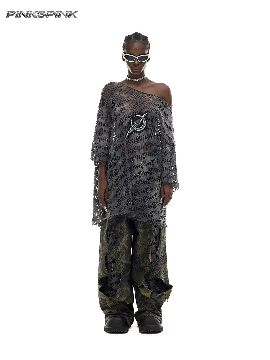 PINKSPINK ELECTRIC MOON distressed open-knit oversized tee in charcoal gray — full-length front modeled view with camouflage trousers