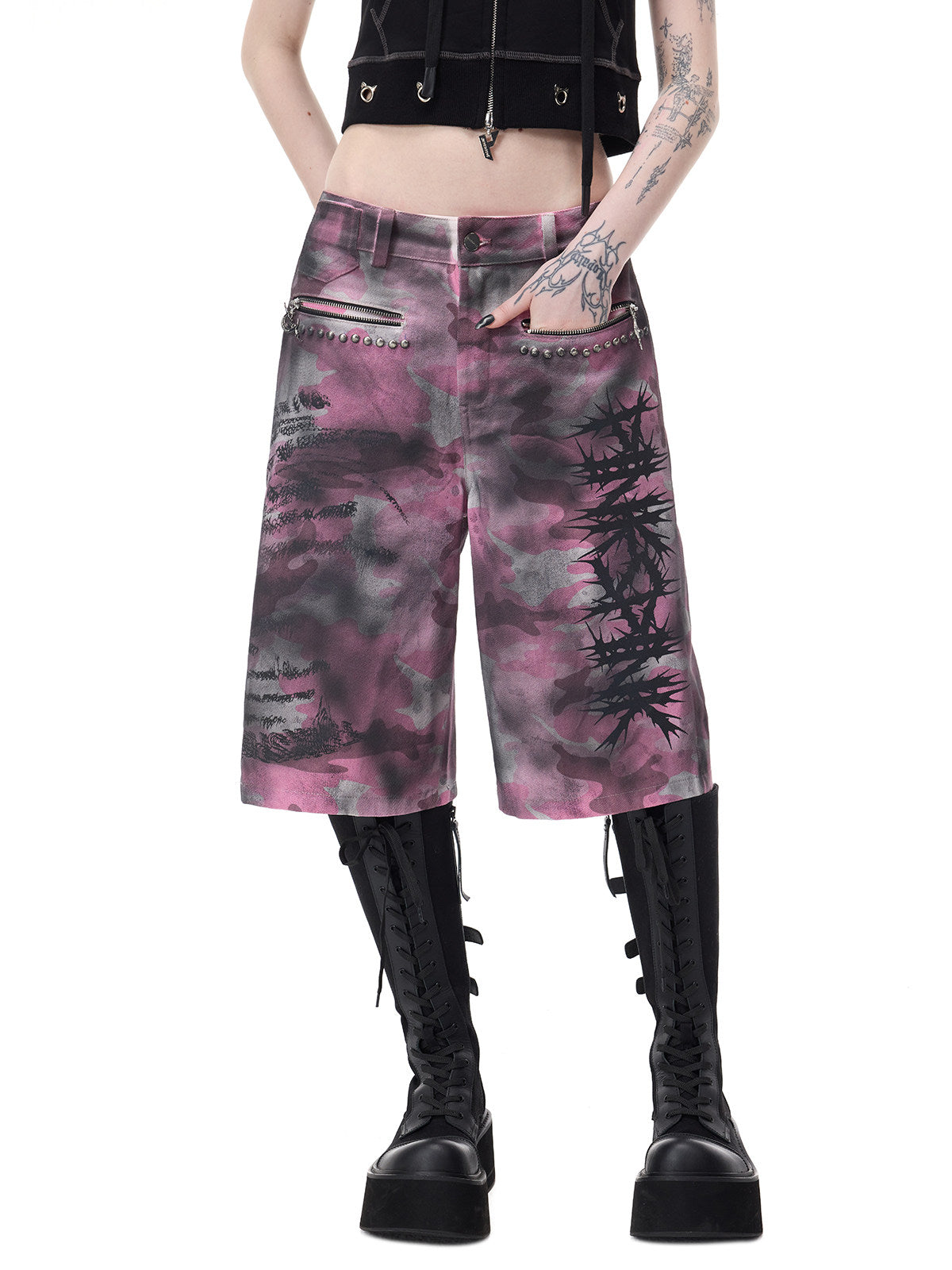 PINKSPINK ELECTRIC MOON coated camouflage denim shorts in pink-gray camouflage — close front view showing both zip pockets and thorn graphic