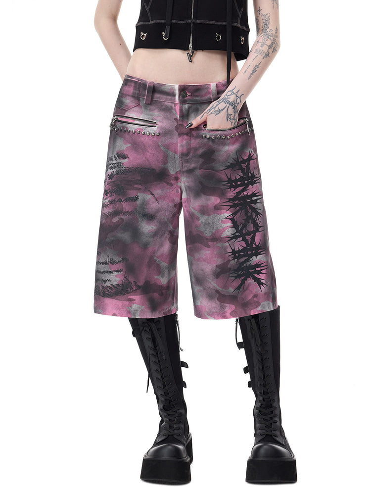 PINKSPINK ELECTRIC MOON coated camouflage denim shorts in pink-gray camouflage — close front view showing both zip pockets and thorn graphic