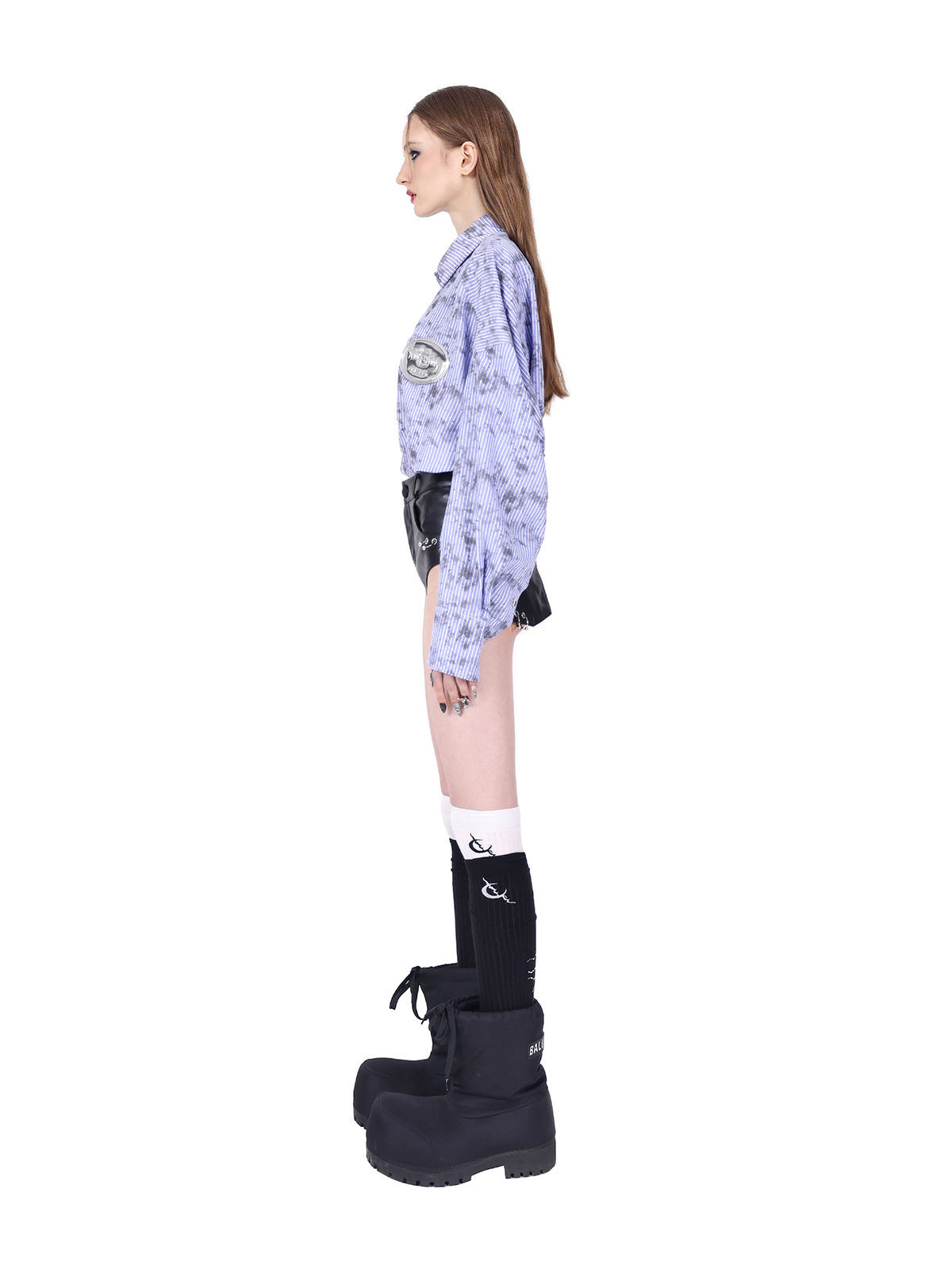PINKSPINK REBEL ring-pierced faux-leather hotpants in black — full side view showing the fitted shape and curved leg opening