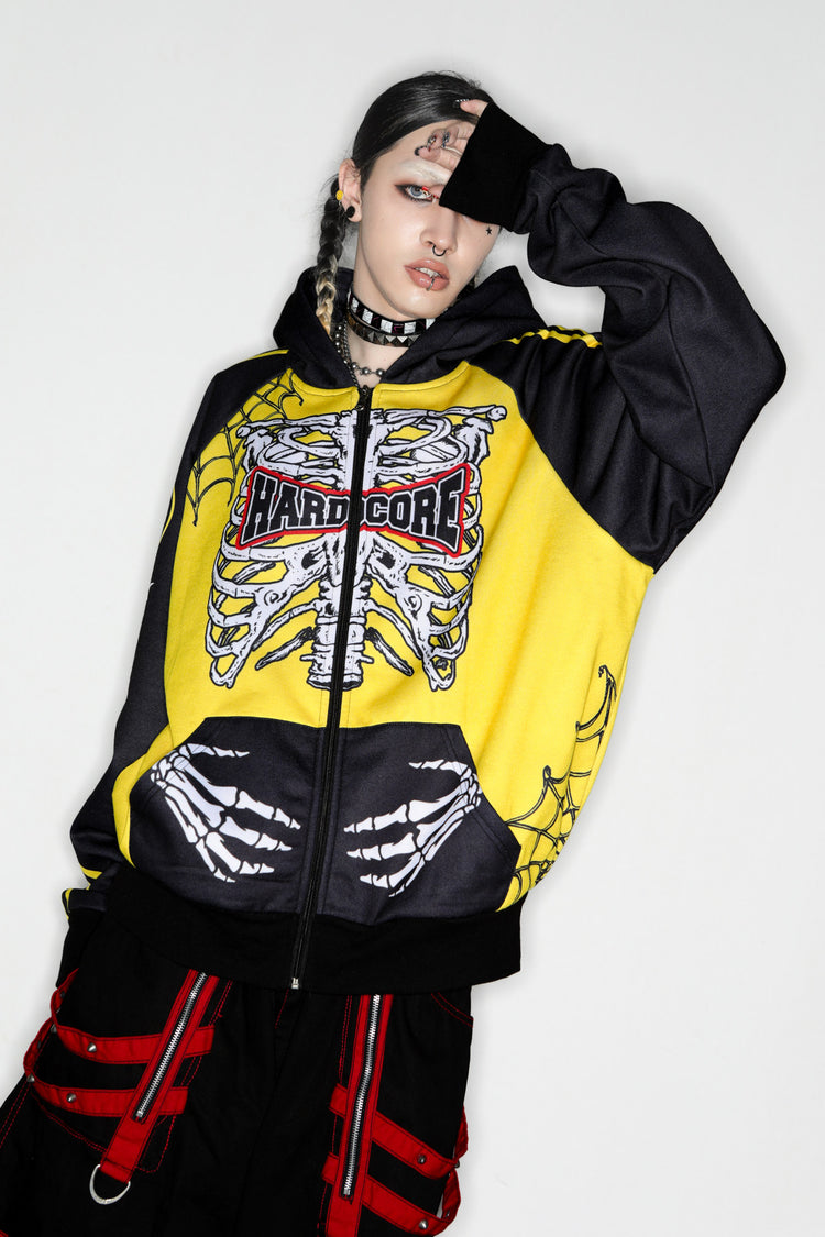 DeadEndKids Hardcore Generation skeleton zip-up hoodie — modeled front, hand across hood