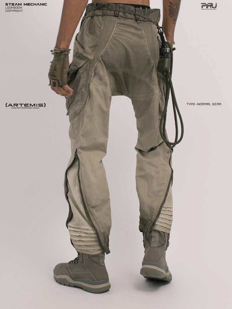 AEGIS lunar soil teal multi-pocket moto pants — rear three-quarter modeled view showing calf zippers