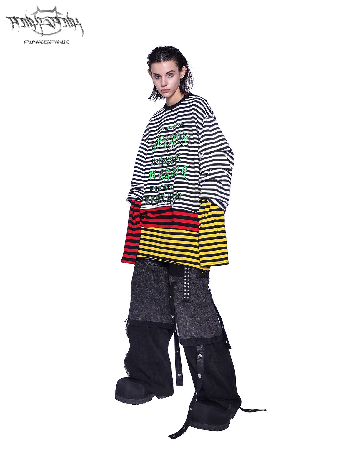 PINKSPINK RECOMBINATION stacked low-rise jeans in black — three-quarter front view styled with a layered striped top.