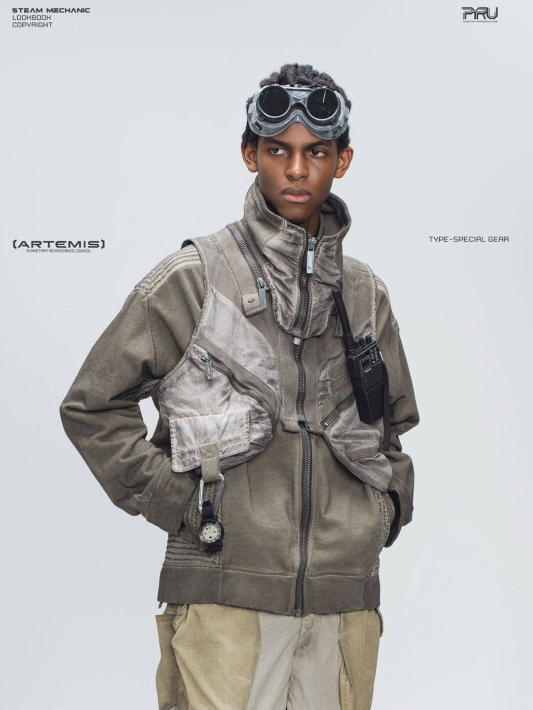 FISSION modular vest — mercury brown front modeled view with hands at the hips
