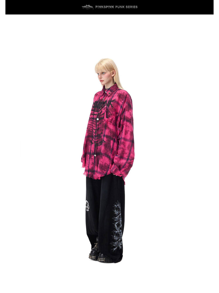 PINKSPINK ELECTRIC MOON distressed oversized plaid shirt in pink and black plaid — full-length angled modeled view over black wide-leg trousers