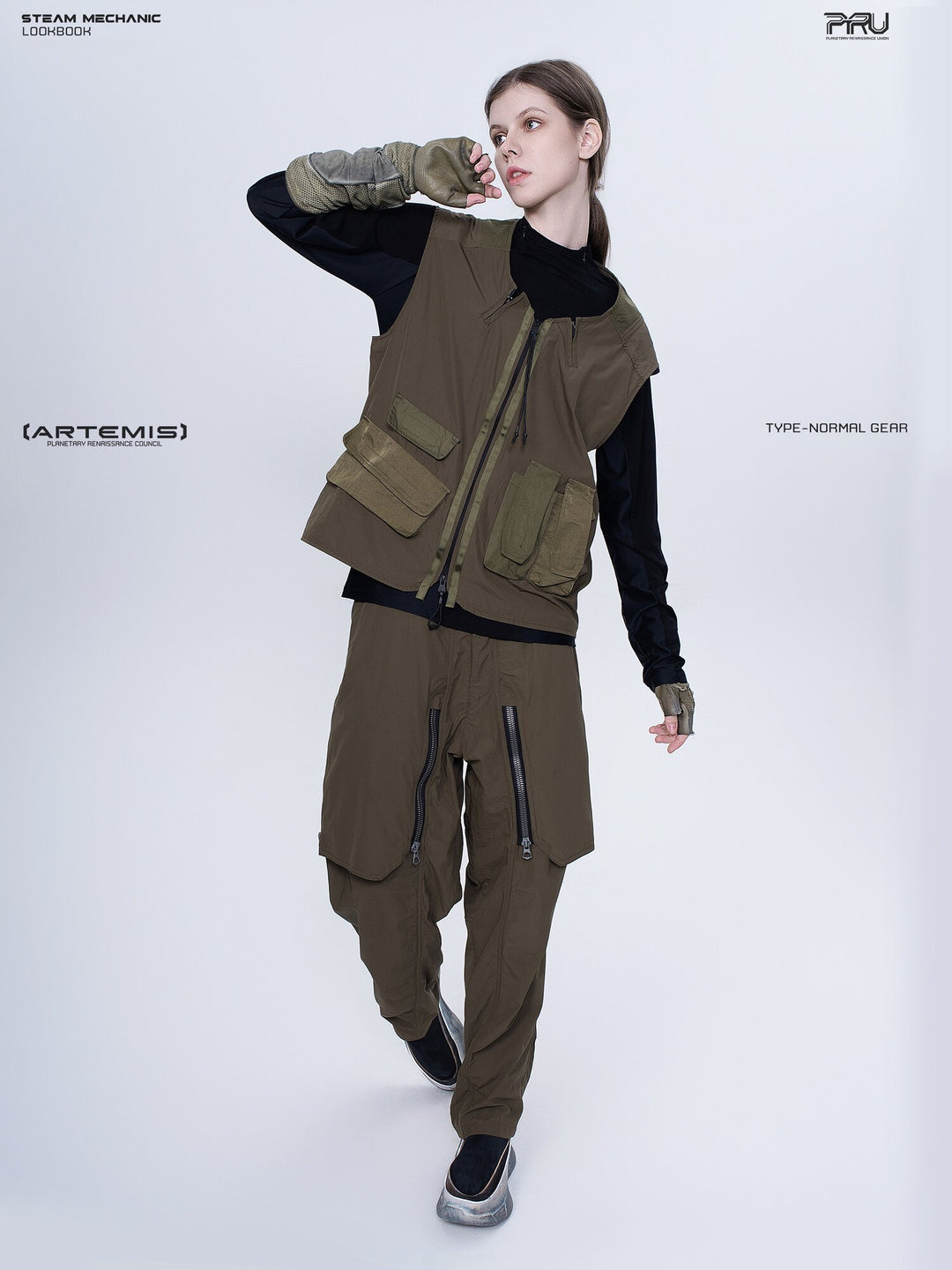 CLERIC utility nylon vest in vine gray green — full-length modeled view with one arm raised