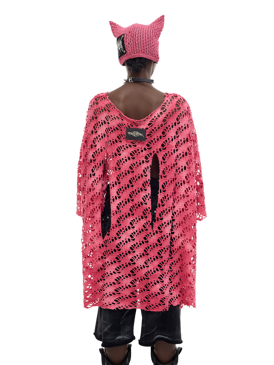 PINKSPINK ELECTRIC MOON distressed open-knit oversized tee in pink — mid-length back modeled view showing the long hem