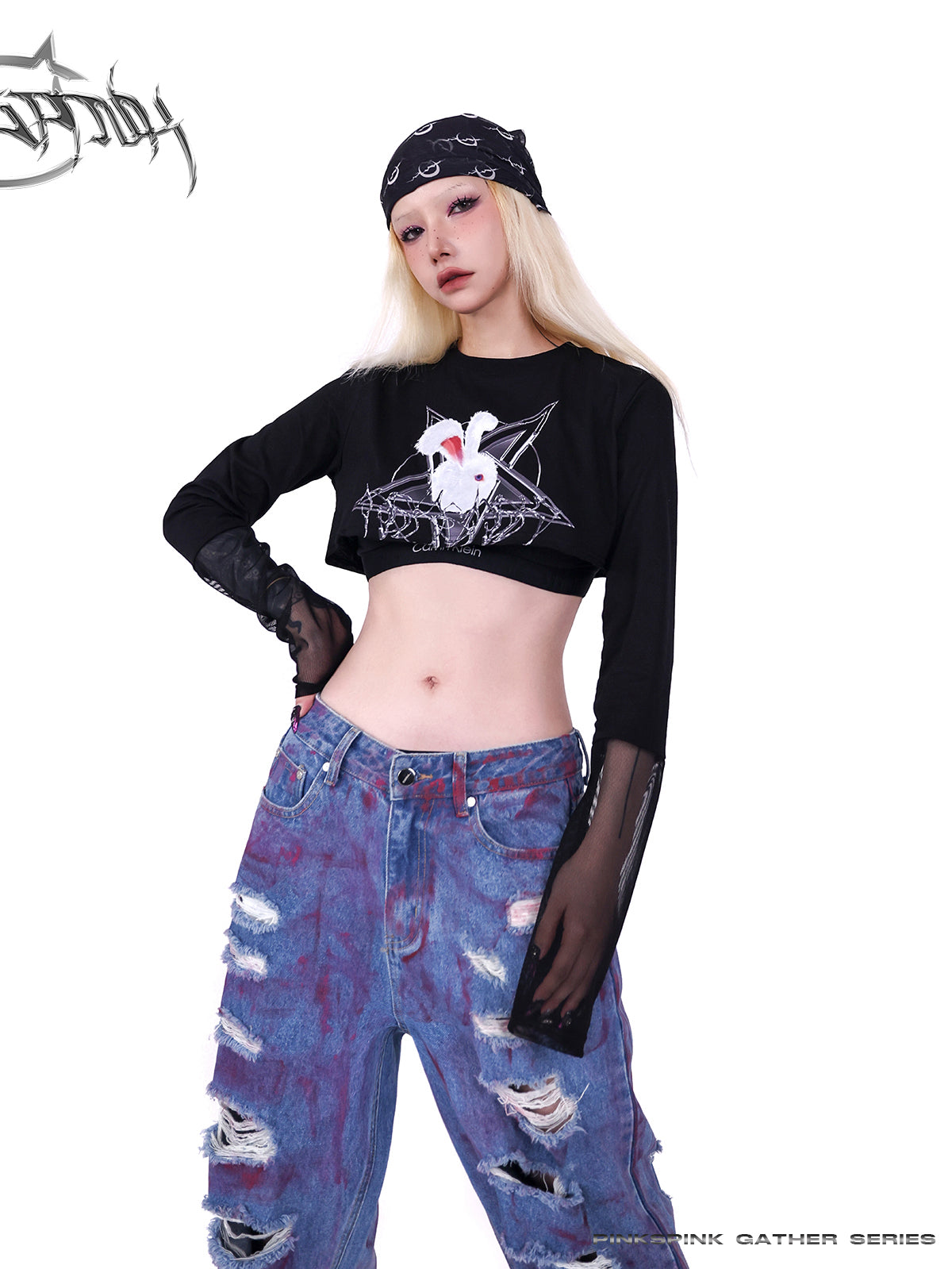 PINKSPINK WASTELAND pink-coated blue jeans — close angled waist-and-thigh view styled with a black crop top