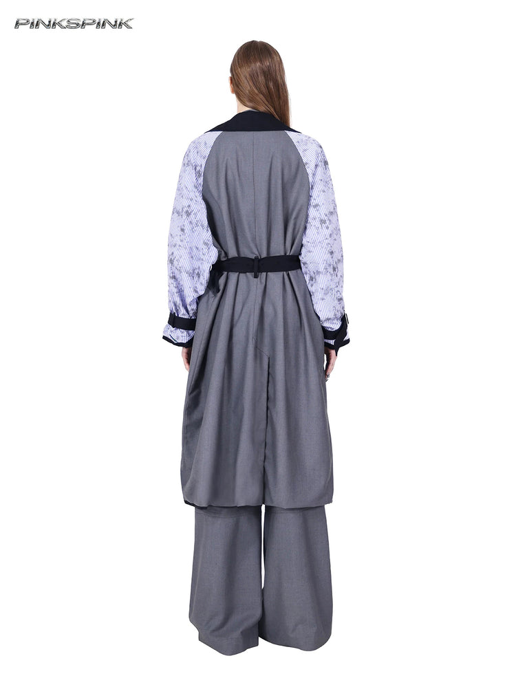 PINKSPINK ELECTRIC MOON reversible patchwork trench coat in black and gray — rear modeled view of the gray reverse with printed striped sleeves