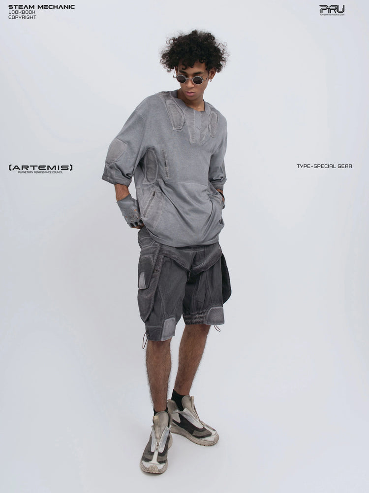 STARCORE stellar blue distressed mesh tee — full-length angled front view with hands in pockets and head lowered