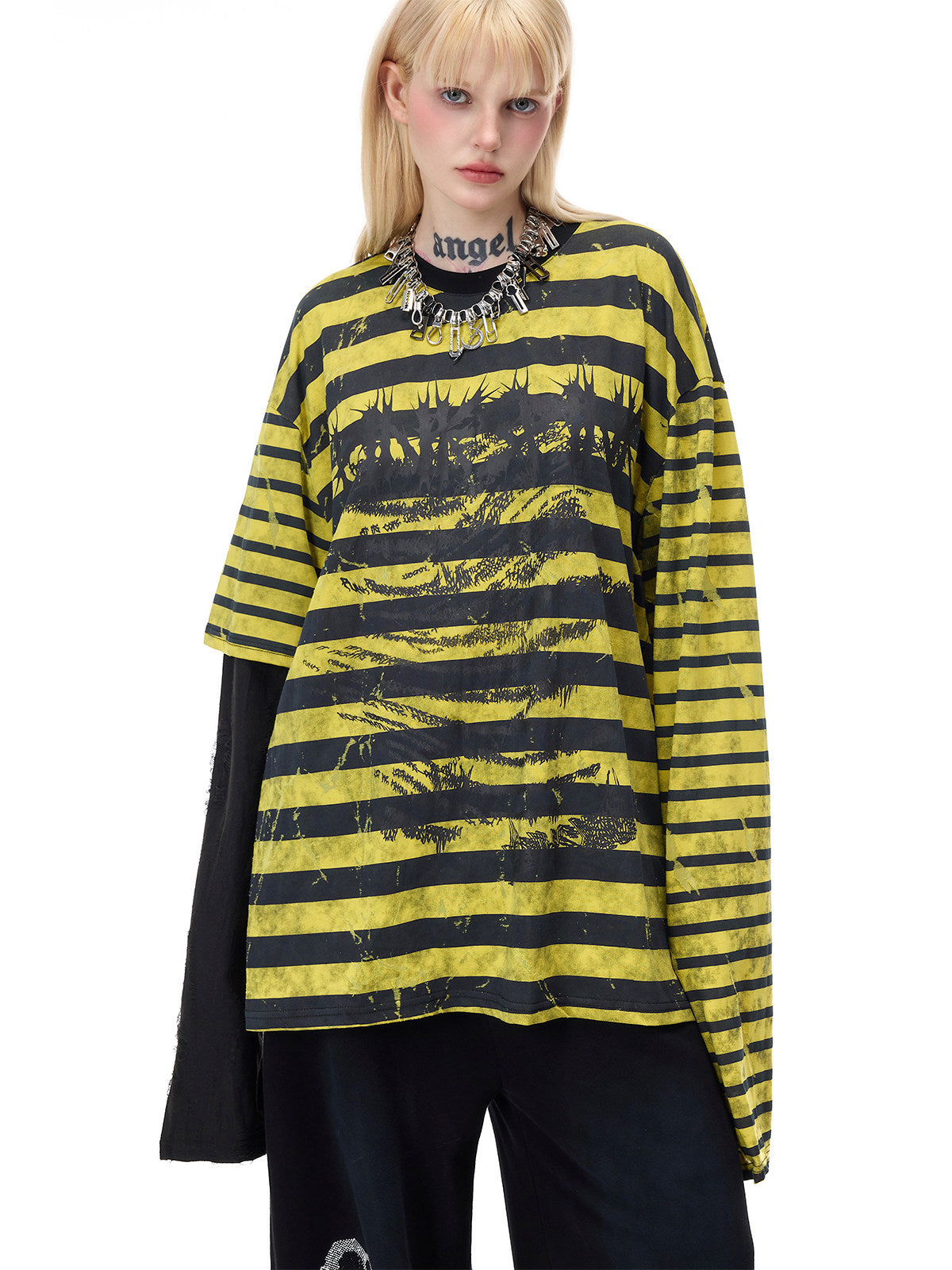 PINKSPINK STATIC asymmetric striped burnout long-sleeve tee in black and yellow — close front modeled view showing the face graphic and contrasting sleeve