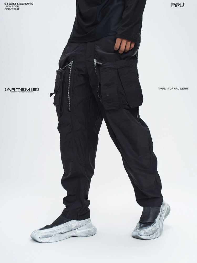 GAIA black curved-blade technical pants — opposite three-quarter modeled view with the overlays open