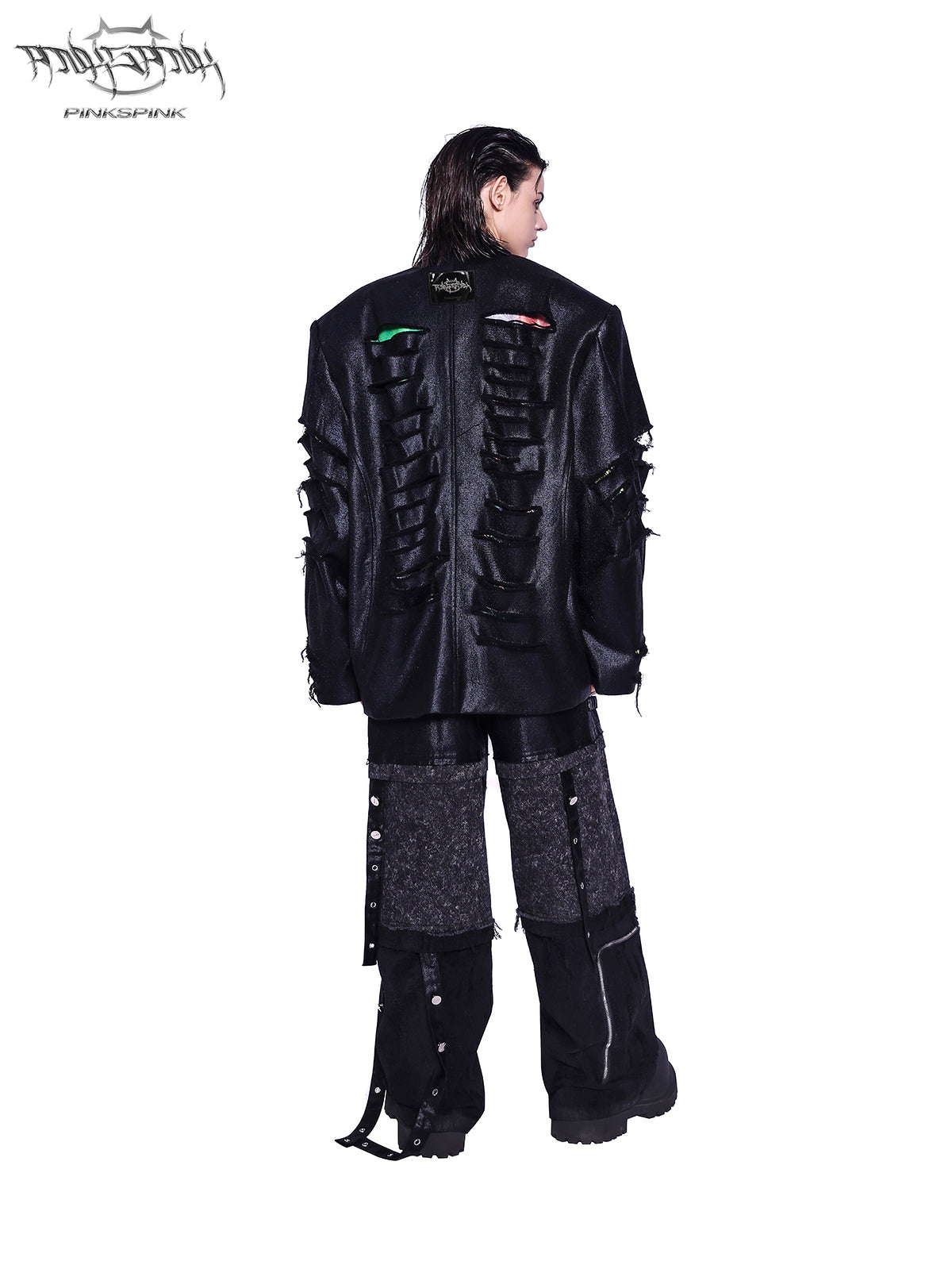 PINKSPINK RECOMBINATION stacked low-rise jeans in black — rear three-quarter view styled with a distressed black jacket.