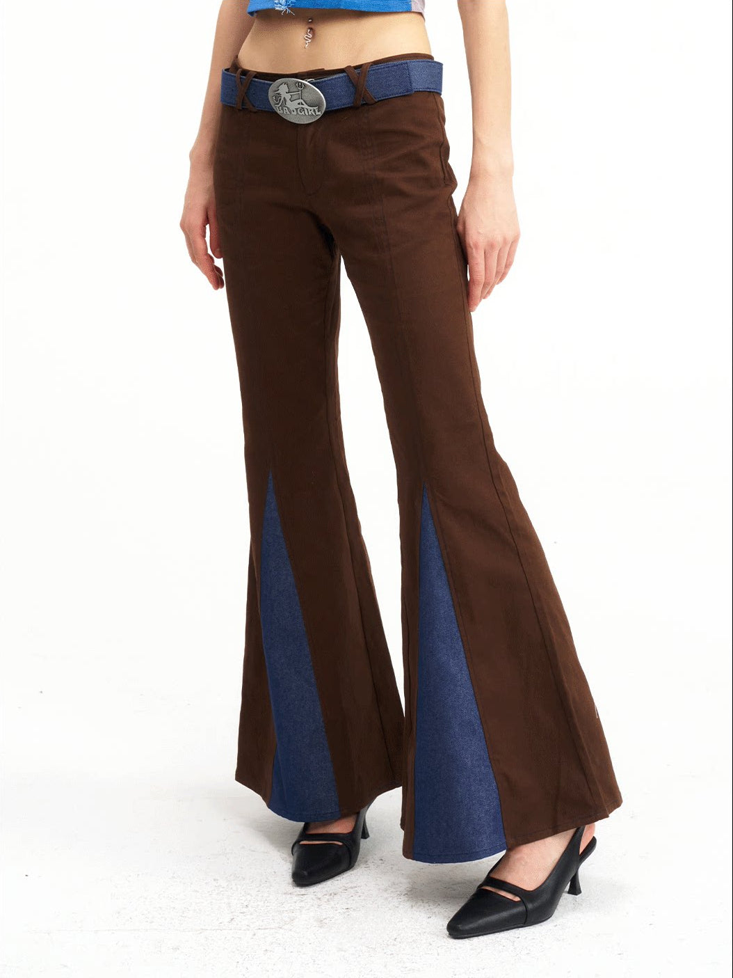 NEXT PASSPORT denim-panel low-rise flared pants in brown — waist-down angled close-up showing the triangular denim inserts.