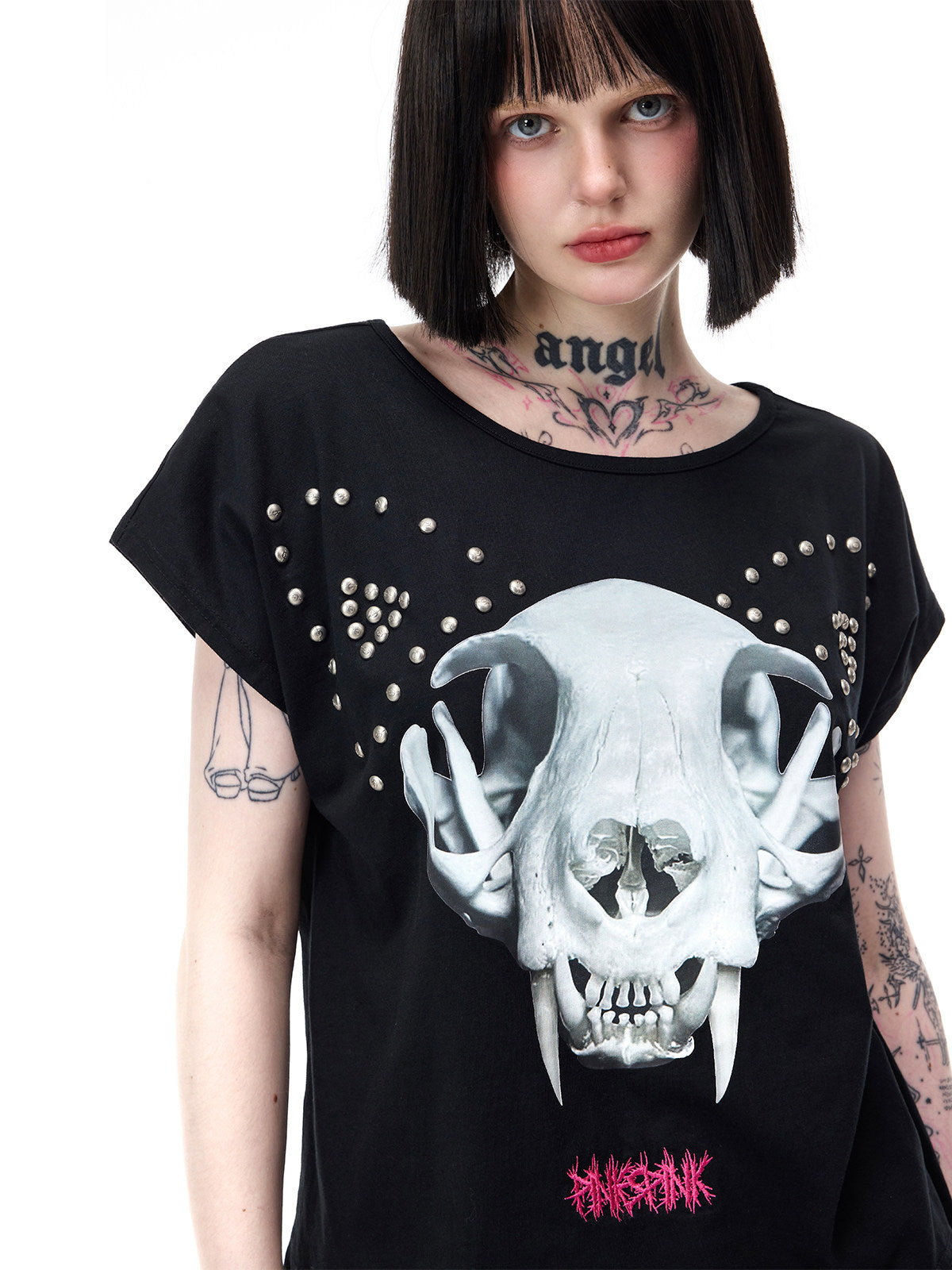 PINKSPINK CATACOMB reversible cat-skull tee in black — close modeled view of the cat-skull print and wing-shaped studs