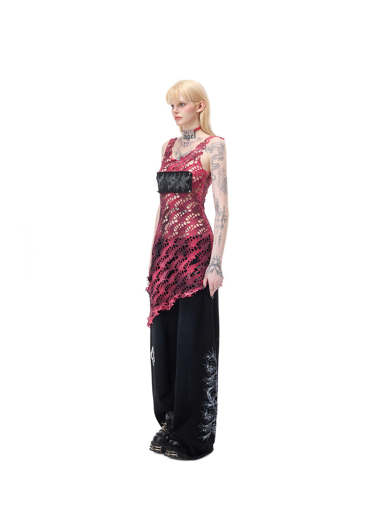 PINKSPINK AFTERGLOW distressed open-knit asymmetric dress in hot pink — full-length side modeled view showing the fitted open knit over separate black trousers