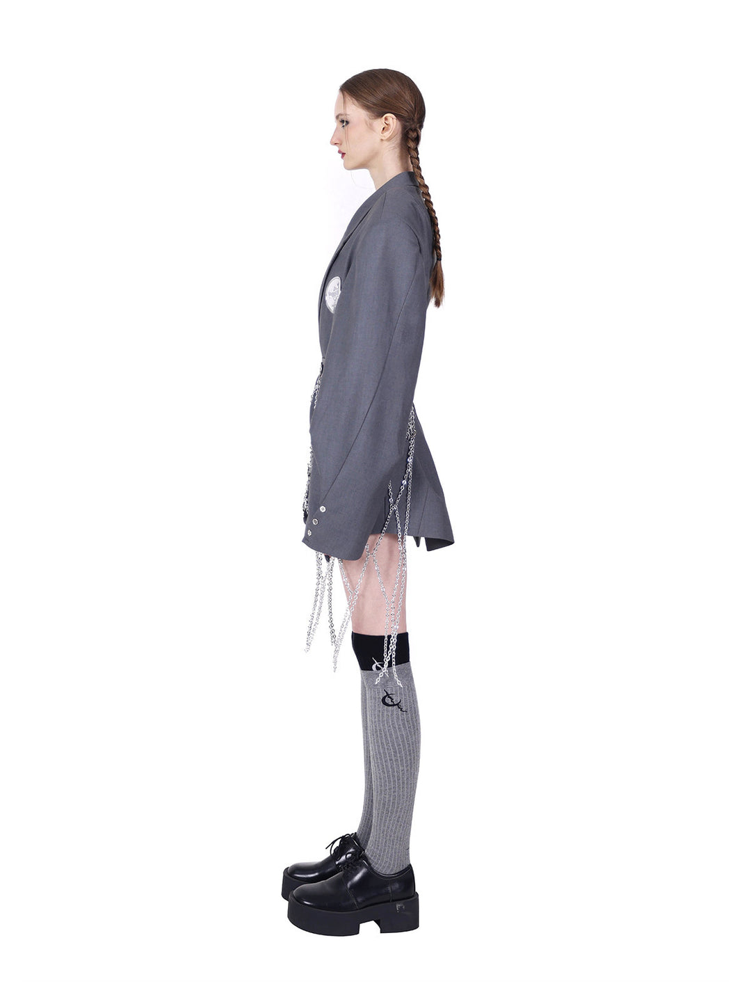 PINKSPINK ELECTRIC MOON diamond-chain belt skirt in black and silver — full-length side view styled over a gray blazer