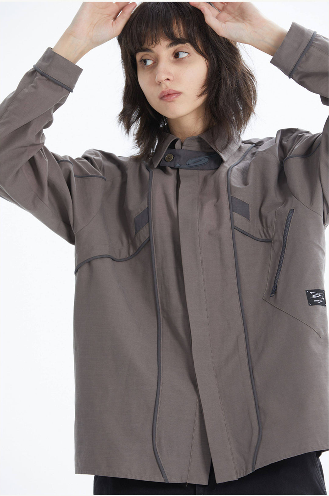 ERRORCODE ROBOT taupe tech work shirt — front modeled view with hands raised