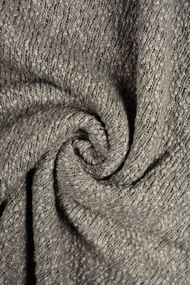 ARTEMIS distressed reversible knit sweater — close-up of the mottled knit texture and soft folded fabric