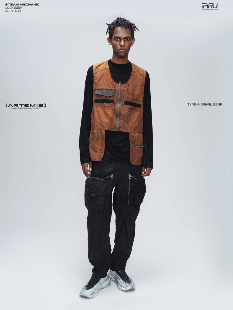 GAIA black curved-blade technical pants — full-length modeled view styled with a brown utility vest