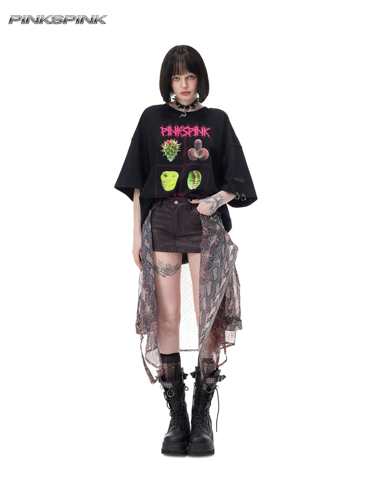 PINKSPINK PLANT PUNK oversized graphic tee in black — full-length front modeled view with the hem tucked into a separate patterned skirt