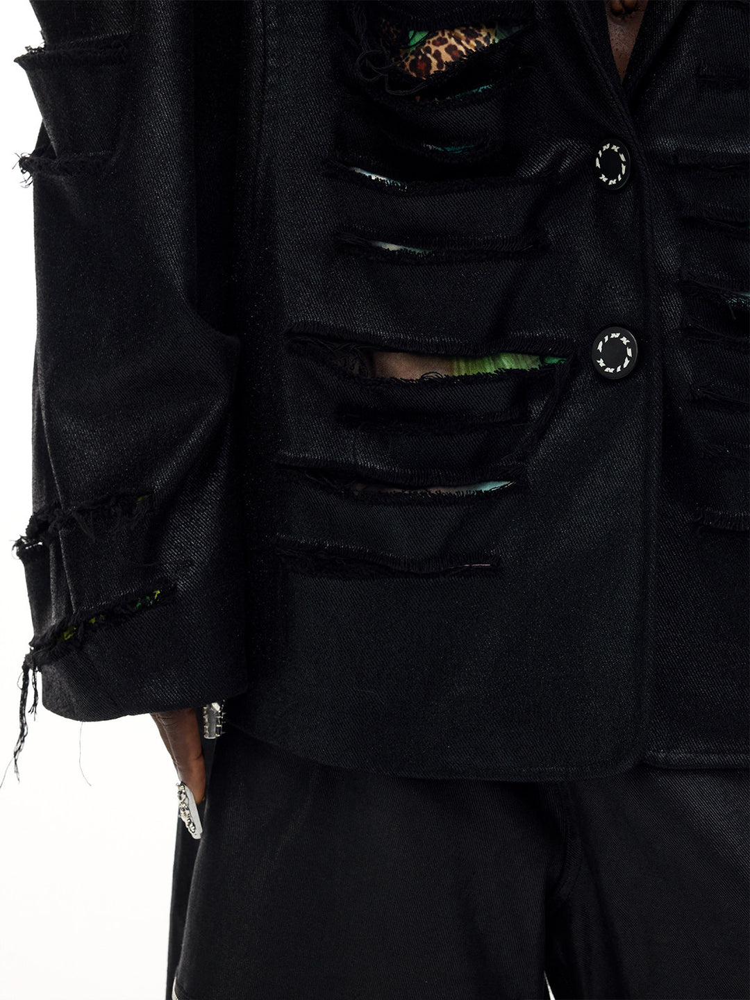 PINKSPINK BREACH distressed coated oversized blazer in black — close-up of the slashed front, printed underlayer and branded buttons