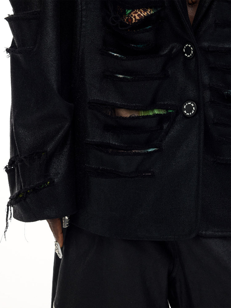 PINKSPINK BREACH distressed coated oversized blazer in black — close-up of the slashed front, printed underlayer and branded buttons