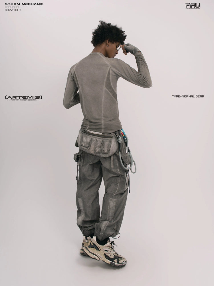 TWIN STAR meteor gray stretch riding base-layer top — full-length back view adjusting sunglasses
