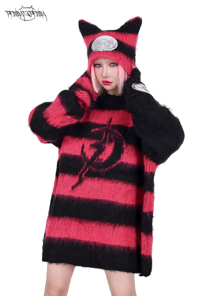 PINKSPINK SPHYNX striped cat-ear knit hat in black pink — front modeled close-up with both hands touching the hat