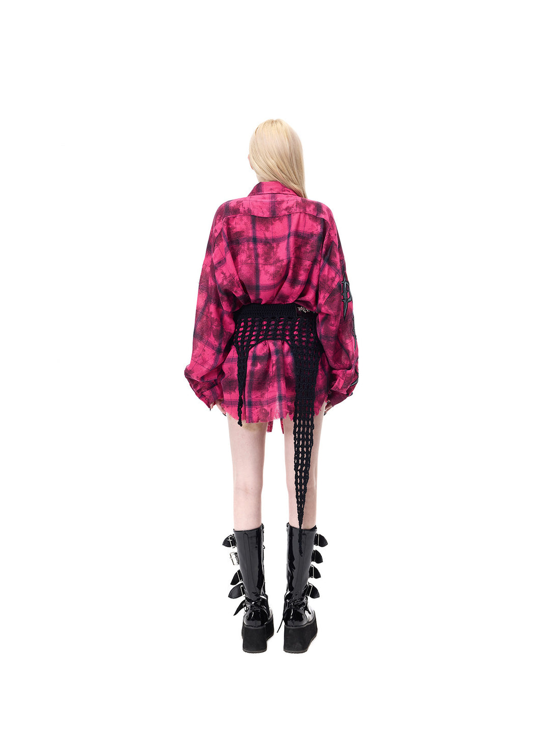 PINKSPINK THORNSTAR open-knit layering skirt in black — full-length rear modeled view over a separate pink plaid shirt