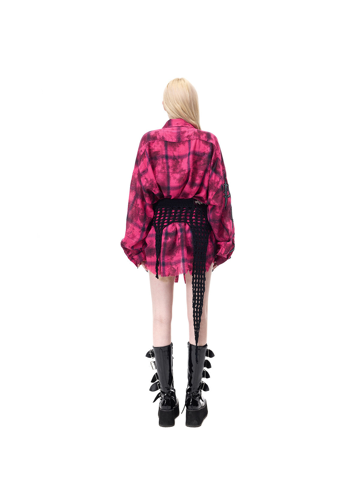 PINKSPINK THORNSTAR open-knit layering skirt in black — full-length rear modeled view over a separate pink plaid shirt