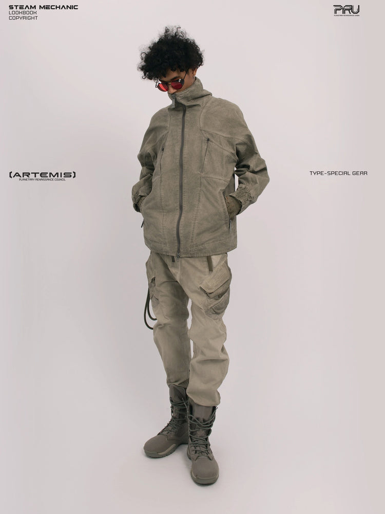 ARTEMIS xirang brown tuck-paneled technical jacket — full-length three-quarter modeled view with the collar zipped and both hands in the pockets
