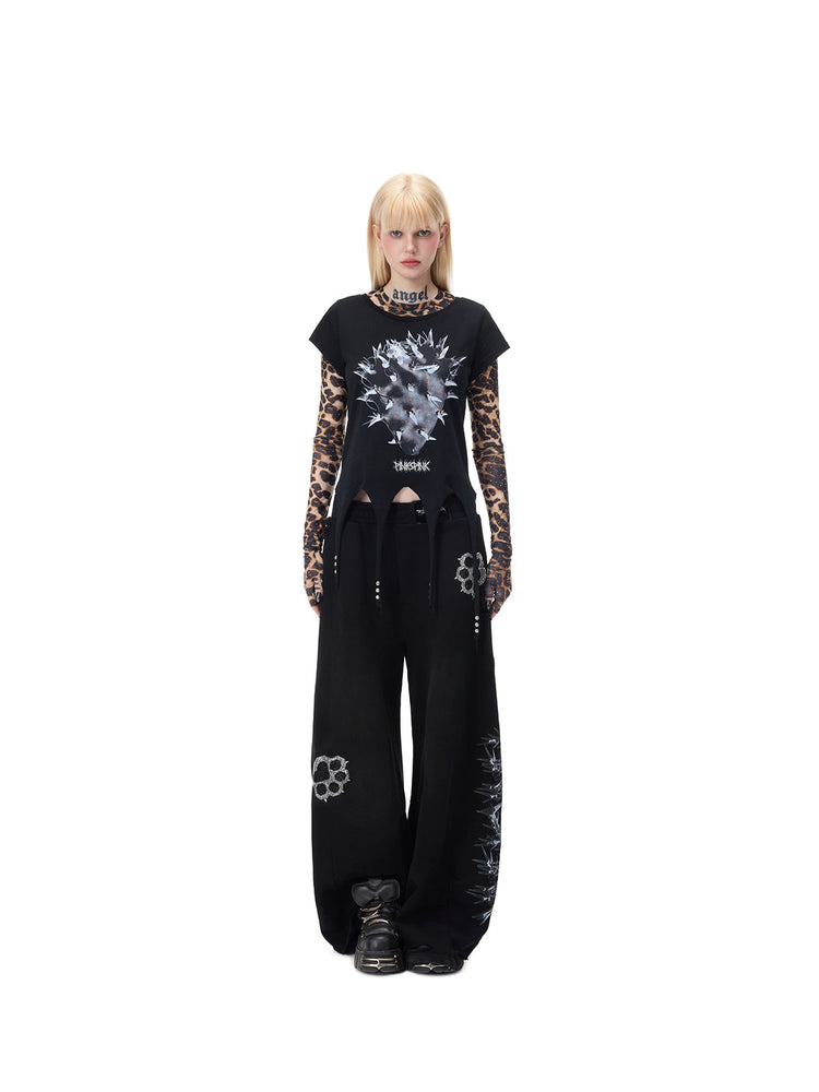 PINKSPINK PUNK CACTUS studded pointed-hem tee in black — centered full-length front modeled view over a separate leopard mesh layer, also shown in the hero collage