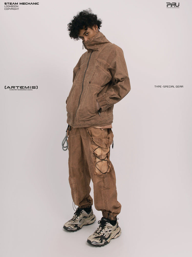 ARTEMIS soft dawn orange tuck-paneled technical jacket — full-length three-quarter modeled view with a hand in the pocket