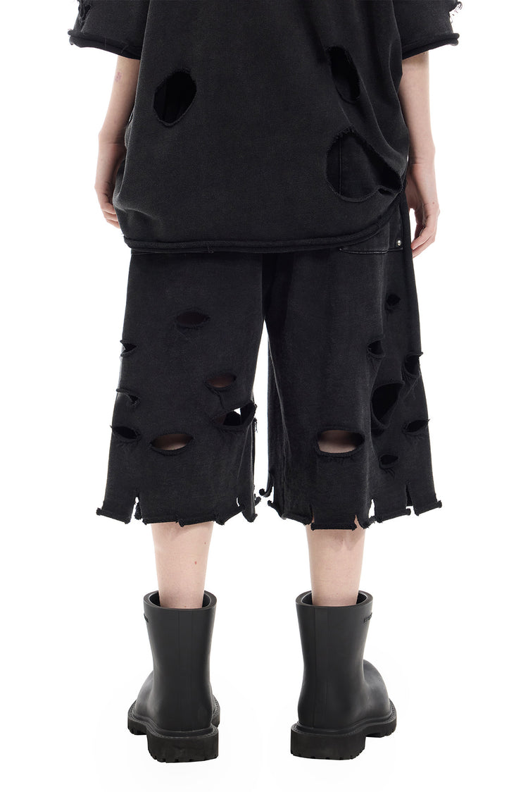 PINKSPINK ELECTRIC MOON distressed embroidered wide-leg shorts — black — back waist-to-hem view showing the patch pocket