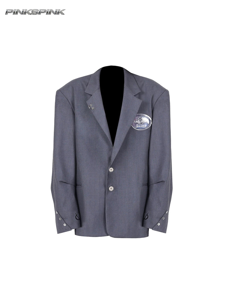 PINKSPINK REBEL pierced oversized tailored blazer in gray — front garment-only view showing pierced lapels and crescent cuff embroidery
