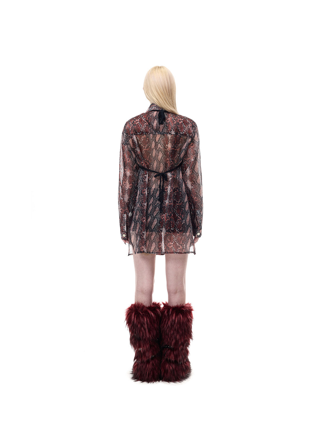 PINKSPINK THORNSTAR open-knit halter top in black — full-length rear modeled view showing the ties over a separate snakeskin-print shirt