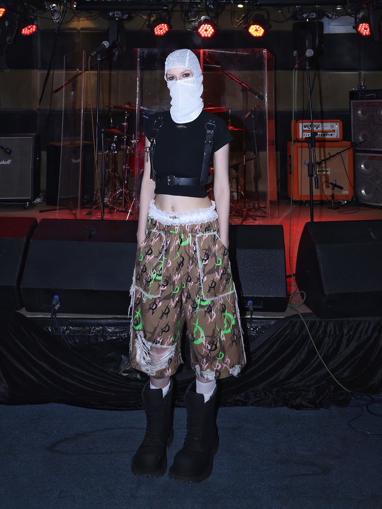 PINKSPINK ELECTRIC MOON distressed camo cropped trousers in CAMOUFLAGE — full front with white mesh hood.